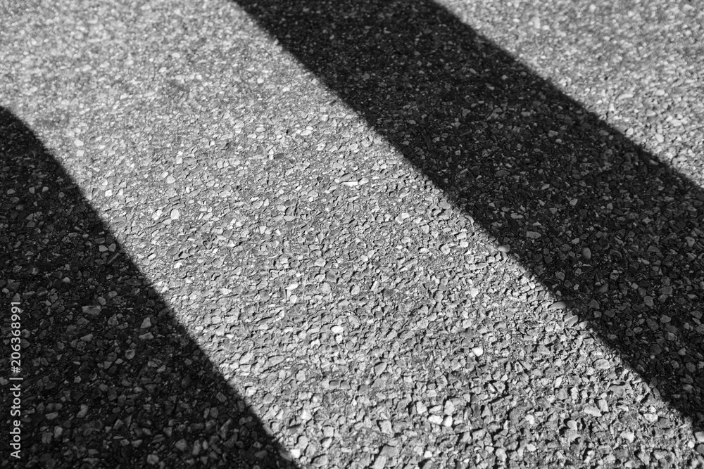 Fototapeta premium diagonal shadows on a aphalt road