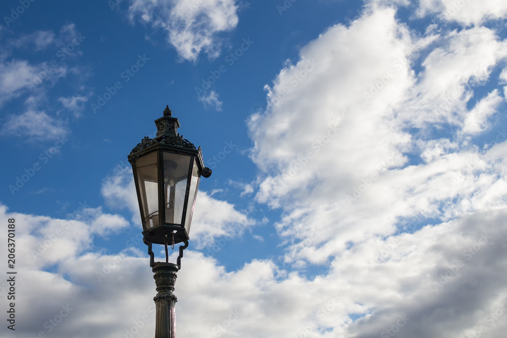 Traditional street lamp - lantern and a blue sky with clouds