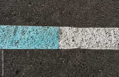 Asphalt road texture with white and blue stripe. Road marking. Urban background