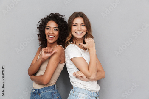 Portrait of two cheerful young women standing together