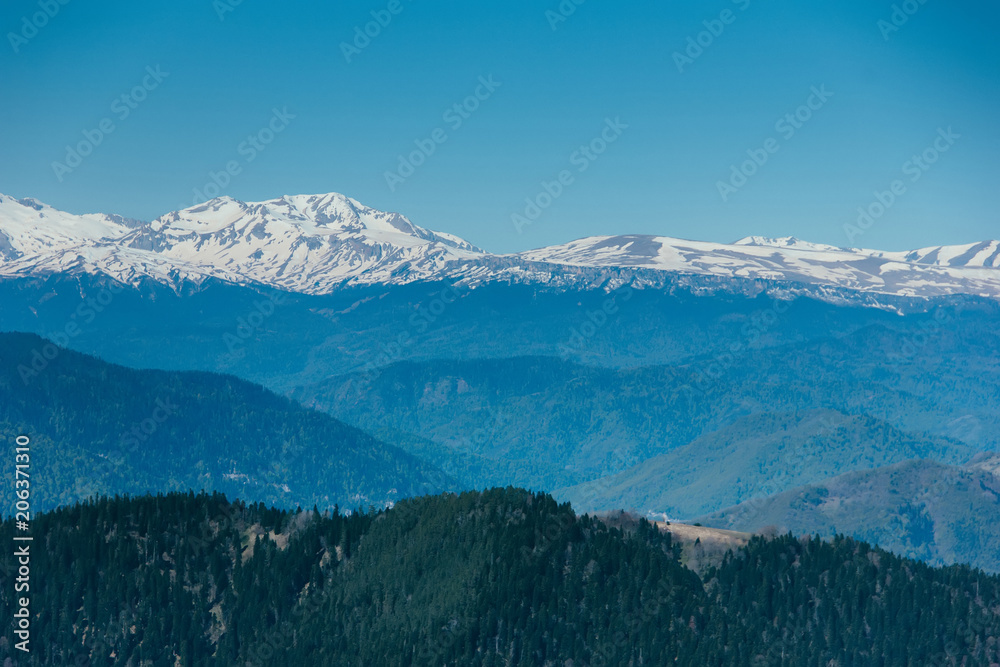 Amazing views in the Caucasus mountains. Snow-capped peaks, blue sky, sunny day