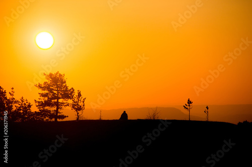 A traveler meets the dawn in the mountains of the Caucasus.