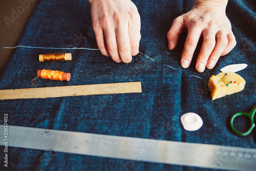 Tailor man working in his tailor shop, Tailoring, close up photo