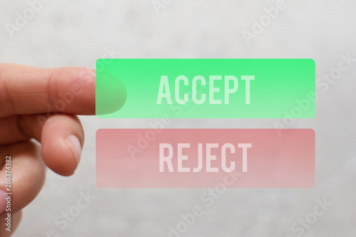 Finger pressing  green accept button on virtual touchscreen on light beige background. Decision making business technology concept.