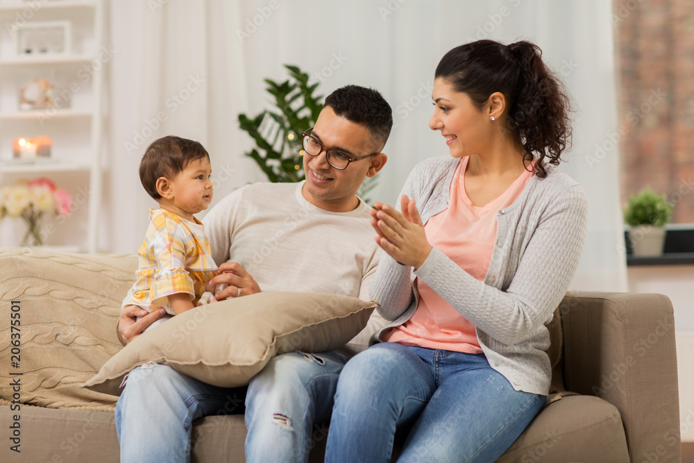 family, parenthood and people concept - happy mother, father with baby daughter at home family, parenthood and people concept - happy mother, father with baby daughter at home
