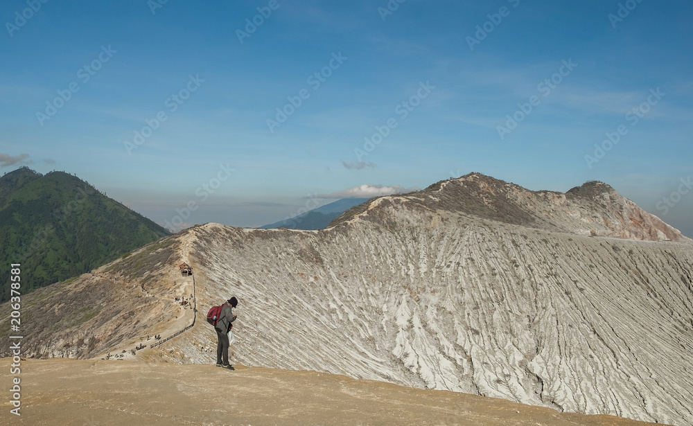 Tourists stand photography and scenic volcano Kawah Ijen in Indonesia.