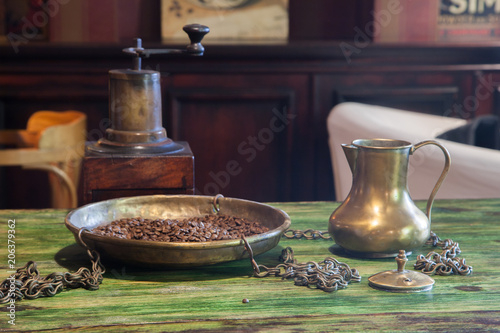 Grains of coffee and a copper coffee pot