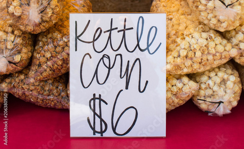 Bagged kettle corn for sale at a summer farmers market or fair.