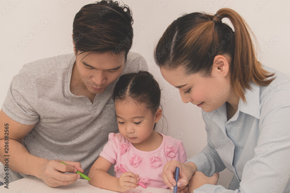 Concept Family. Familys are drawing activities in the home. Family is doing happy activities. Parents are teaching drawing children. Concept Family. Familys are drawing activities in the home. Family is doing happy activities. Parents are teaching drawing children.