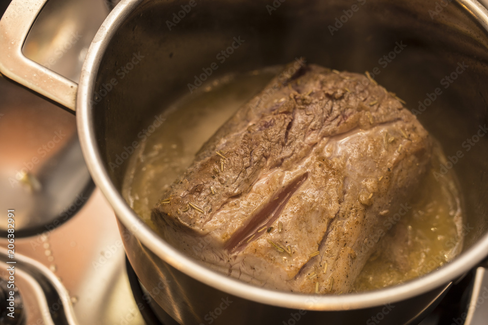 piece of meat in the pot during cooking piece of meat in the pot during cooking