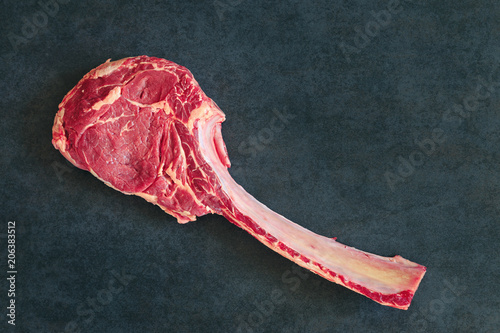 Dry aged raw tomahawk  steak photo