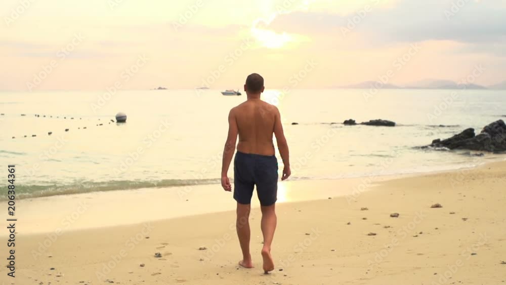 Young man walking on beach, super slow motion 240fps
Young man walking on beach, super slow motion 240fps