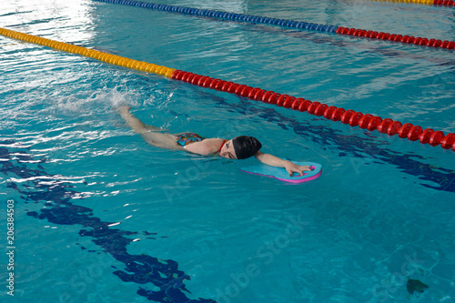 The girl in the water with a supporting Board