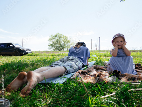 Dad and daughter picnic in the park on the grass