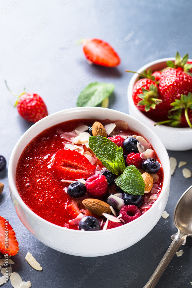 Smoothie bowl with fresh berries and nuts. 