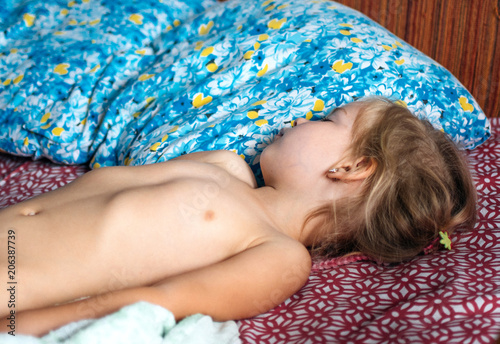 A child sleeps in the bed morning sleep