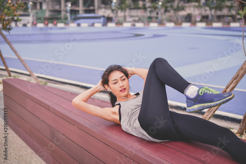 Sports concept. Beautiful girl is exercising on the beach with warm up. Beautiful girl is happy to exercise. photo