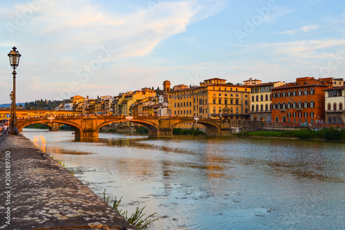 Arno river with Ponte Santa Trinita (Holy Trinity Bridge) and Ponte Vecchio at the evening, in Florence, Italy.