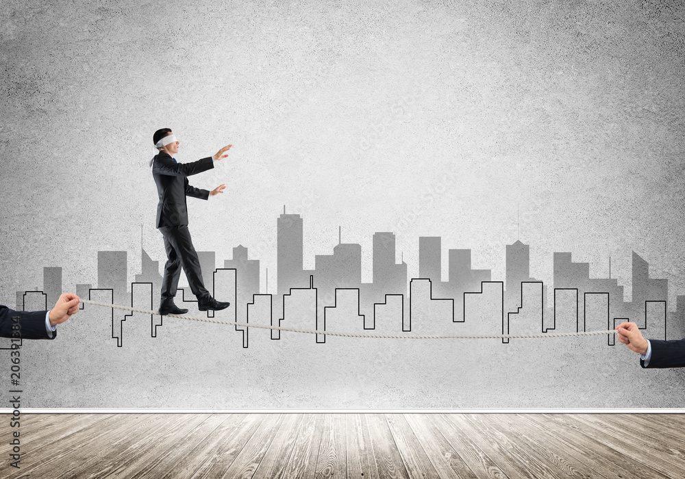 Business concept of risk support and assistance with man balancing on rope