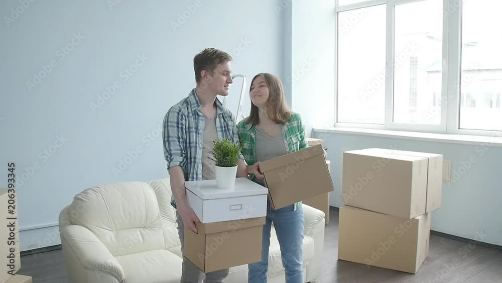 Happy young couple with cardboard boxes moves to new apartment Happy young couple with cardboard boxes moves to new apartment
