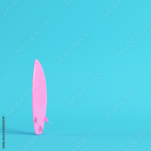 Pink surfboard on bright blue background in pastel colors. Minimalism concept