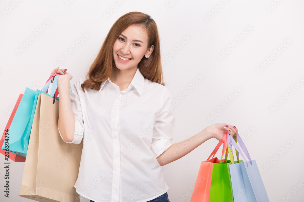 Very happy beautiful young woman in casual clothing with shopping bags Very happy beautiful young woman in casual clothing with shopping bags