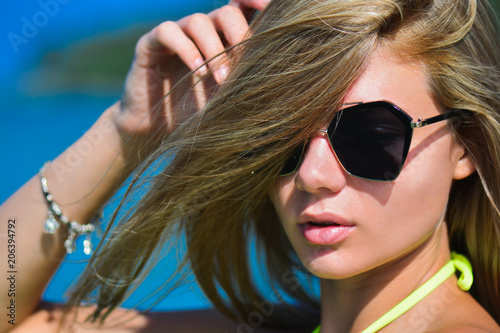 Closeup fashion beautiful woman portrait wearing sunglasses. Portrait of happy teenage girl in sunglasses. Summer lady