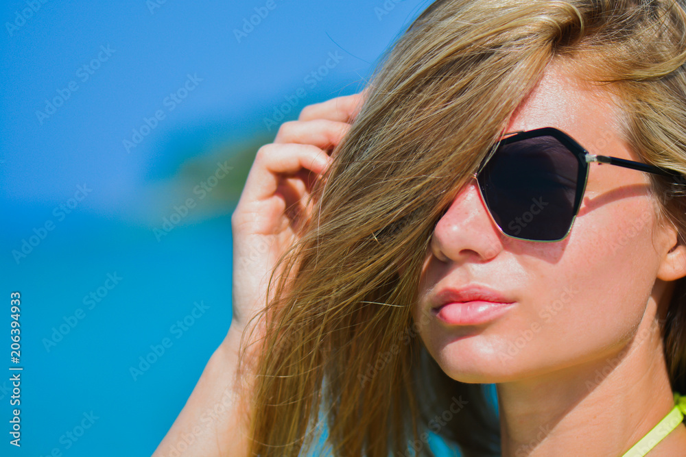 Closeup fashion beautiful woman portrait wearing sunglasses. Portrait of happy teenage girl in sunglasses. Summer lady Closeup fashion beautiful woman portrait wearing sunglasses. Portrait of happy teenage girl in sunglasses. Summer lady