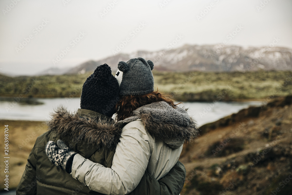 Young couple hugging staring the horizon