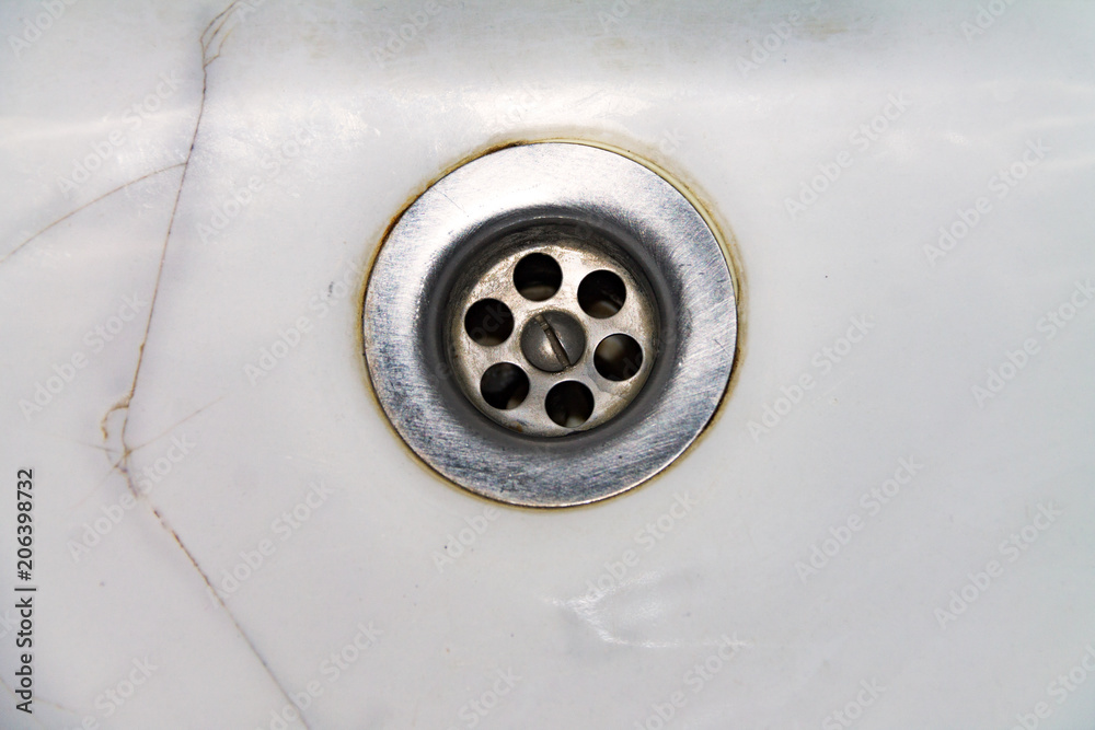 View of the sink, drain and flowing water for background, close-up View of the sink, drain and flowing water for background, close-up