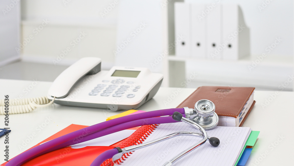 Doctor's workspace working table with patient's discharge blank paper form, medical prescription, stethoscope on desk Doctor's workspace working table with patient's discharge blank paper form, medical prescription, stethoscope on desk
