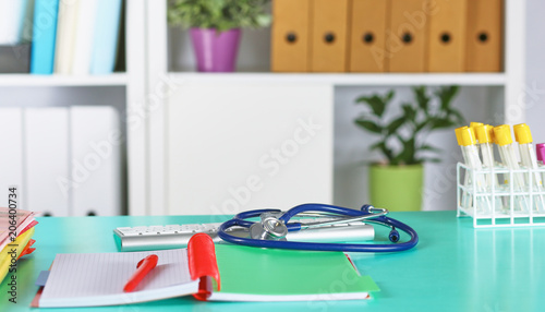 Doctor s workspace working table with patient s discharge blank paper form  medical prescription  stethoscope on desk