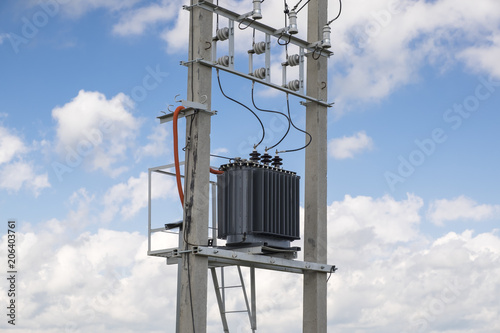 Photography Electric transformer stands on concrete supports.