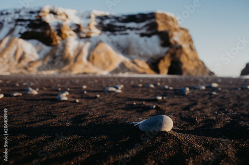 Some stones at a black sand beach in Iceland at sunset