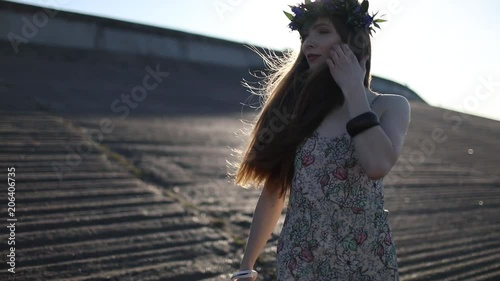 Young beautiful woman walking on the beach photo