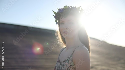 Young beautiful woman walking on the beach photo