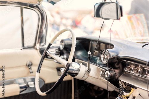 Retro car interior. Steering wheel and driver seat of vintage  vehicle. Classic  old automoile dashboard