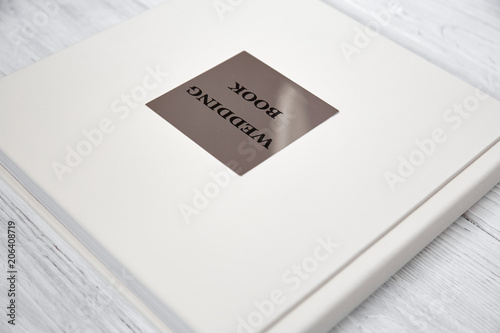 light wedding book on a white wooden background