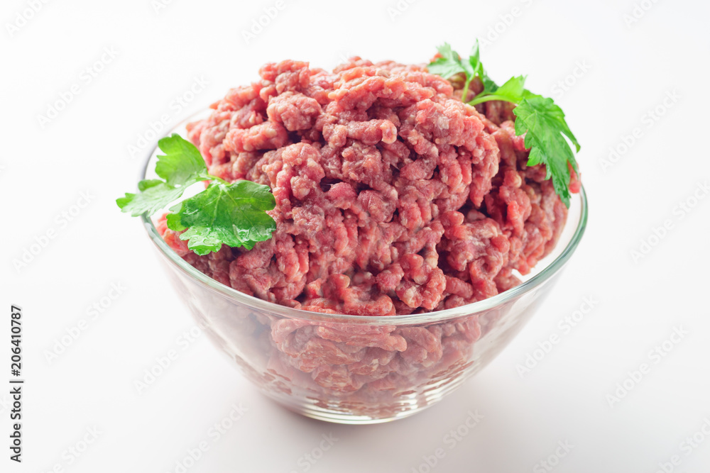 Raw minced meat in a plate on white background Raw minced meat in a plate on white background