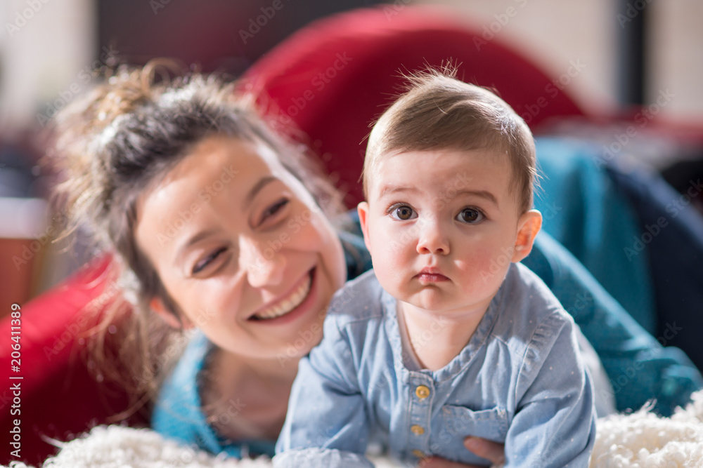 Mum plays with her cheerful baby at home Mum plays with her cheerful baby at home