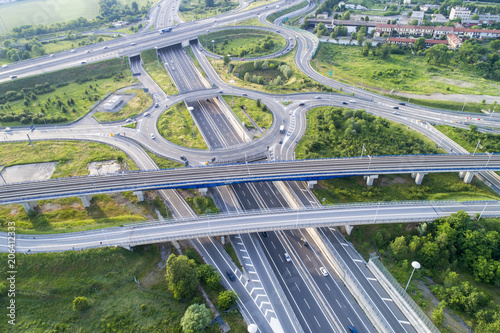 Aerial view of highway road junction. Highways, railway and green fields on the outskirts of the city. Transport concept.outskirts of the city. Transport concept.
