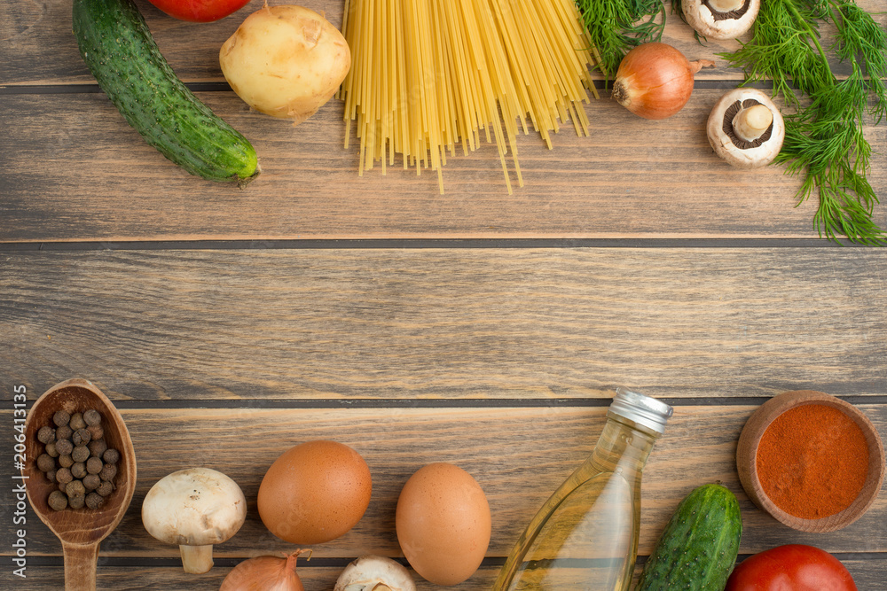 Fresh vegetables and spaghetti, on a wooden texture with an empty space for the inscription. Fresh vegetables and spaghetti, on a wooden texture with an empty space for the inscription.