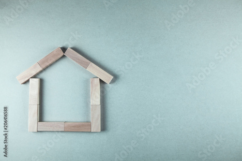 Wooden house. Made of wood blocks on table.