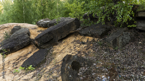 Stones on the yellow sand in a granite quarry