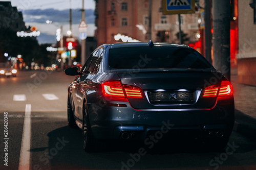Luxury sport car night view on city street © pha88