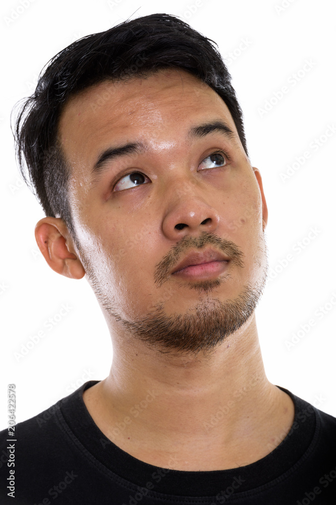 Fototapeta premium Face of young Asian man thinking while looking up