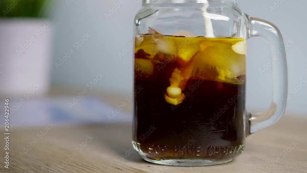 Creamer Pouring Into Cold Brew Coffee In Slow Motion Creamer Pouring Into Cold Brew Coffee In Slow Motion