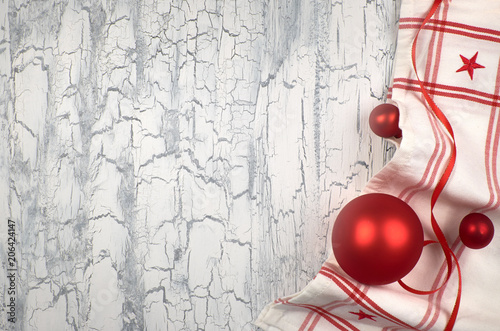 Christmas background with napkins  red baubles and ribbon on rustic wood  text