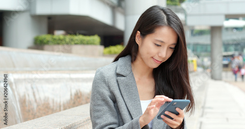 Photography Businesswoman use of smart phone in Hong Kong