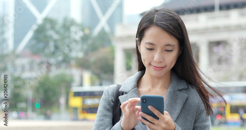 Photography Business woman use of smart phone in Hong Kong
